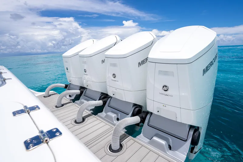 Slide: The Image of 2023 Front Runner 47 Center Console with triple Mercury outboard engines on turquoise water. - 1