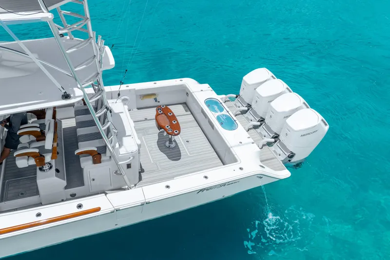 Slide: The Image of 2023 Front Runner 47 Center Console boat with quad outboard engines on turquoise water. - 10