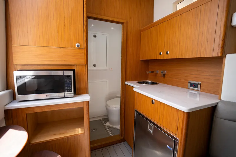 Slide: The Image of 2023 Front Runner 47 Center Console interior with kitchenette and bathroom. - 21