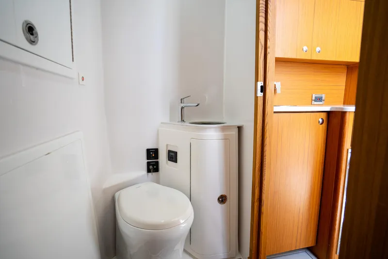 Slide: The Image of 2023 Front Runner 47 Center Console boat bathroom with toilet and sink. - 22