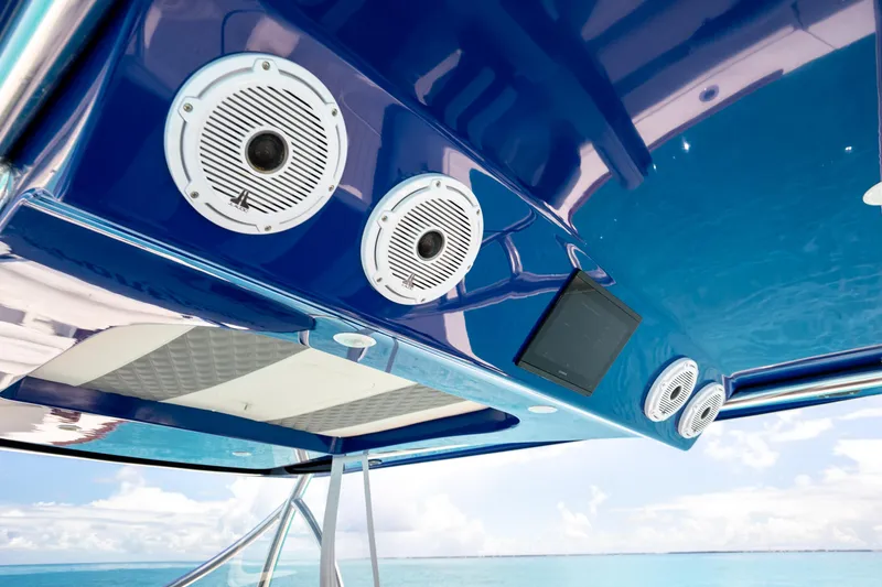 Slide: The Image of 2023 Front Runner 47 Center Console boat with blue canopy and speakers. - 24