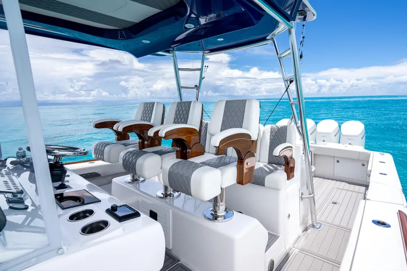 Slide: The Image of 2023 Front Runner 47 Center Console boat with luxurious seating and ocean backdrop. - 28