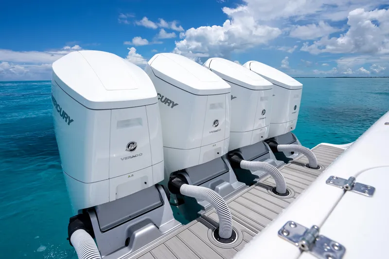 Slide: The Image of Four Mercury outboard engines on a 2023 Front Runner 47 Center Console boat in clear blue water. - 39