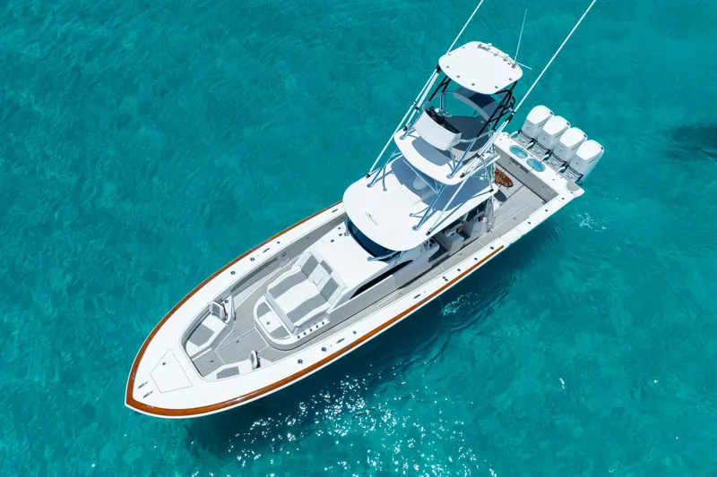 Slide: The Image of 2023 Front Runner 47 Center Console boat on clear blue water. - 47