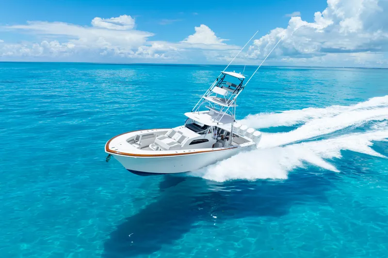 Slide: The Image of 2023 Front Runner 47 Center Console boat cruising on clear blue ocean. - 49