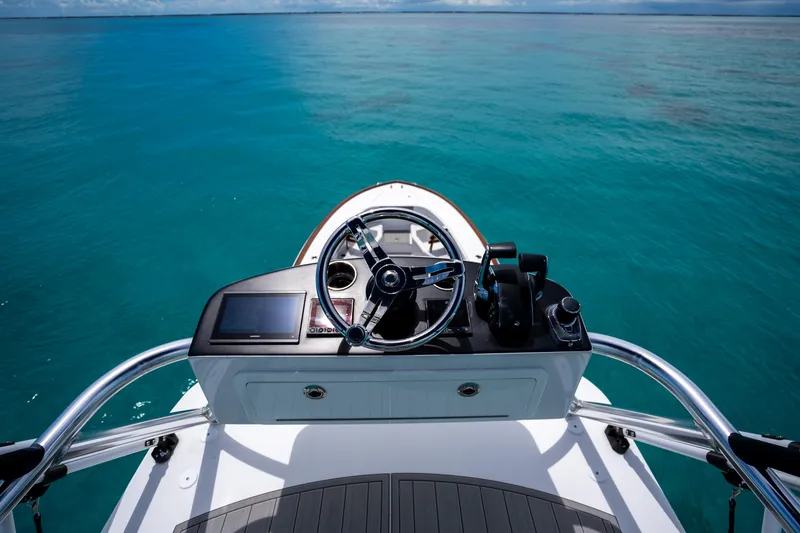 Slide: The Image of 2023 Front Runner 47 Center Console helm on open water. - 7