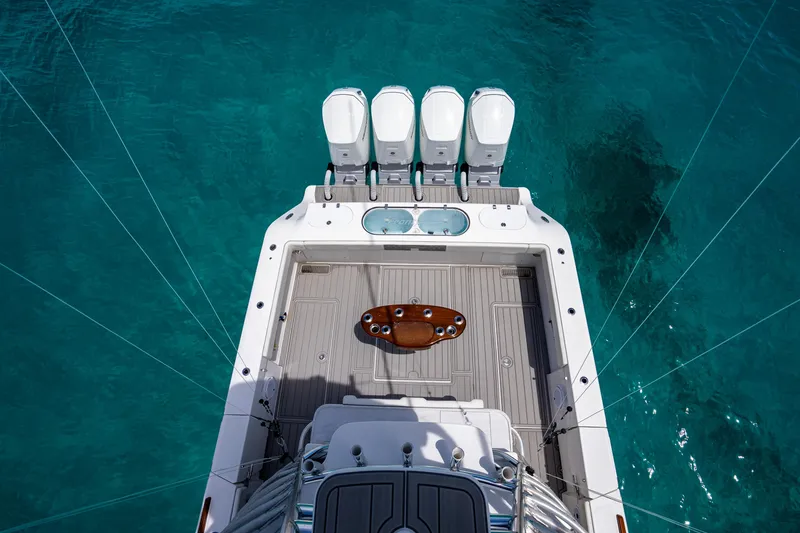 Slide: The Image of 2023 Front Runner 47 Center Console boat with four engines on clear blue water. - 9