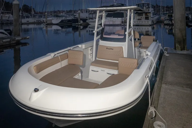 Slide: The Image of 2022 Bayliner Trophy T22CC boat docked at marina during twilight. - 11