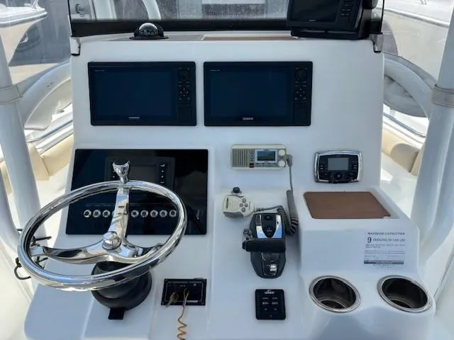 Slide: The Image of 2017 Sea Pro 219 Center Console boat dashboard with steering wheel and navigation equipment. - 10
