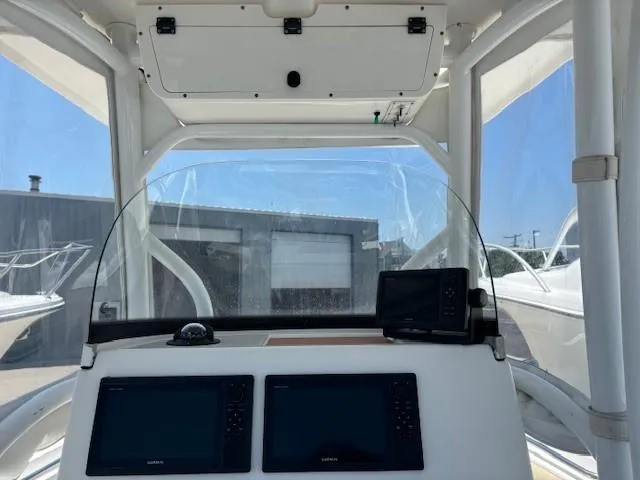 Slide: The Image of 2017 Sea Pro 219 Center Console boat dashboard with navigation screens and controls. - 13
