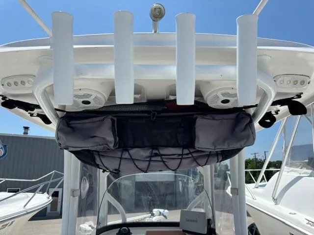 Slide: The Image of 2017 Sea Pro 219 Center Console boat with T-top rod holders and storage. - 14
