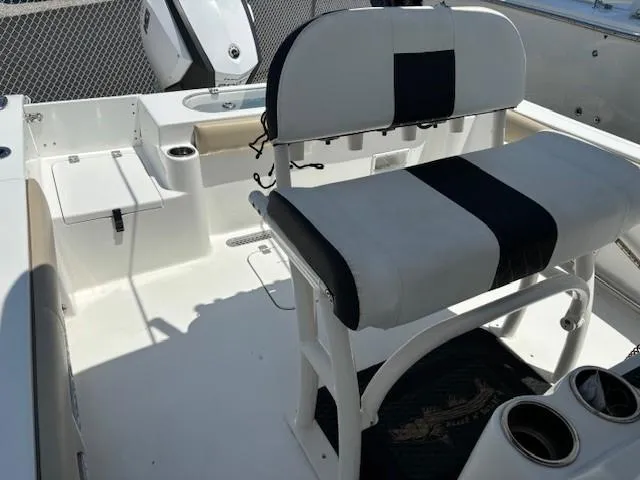 Slide: The Image of 2017 Sea Pro 219 Center Console boat interior with seating and cup holders. - 15