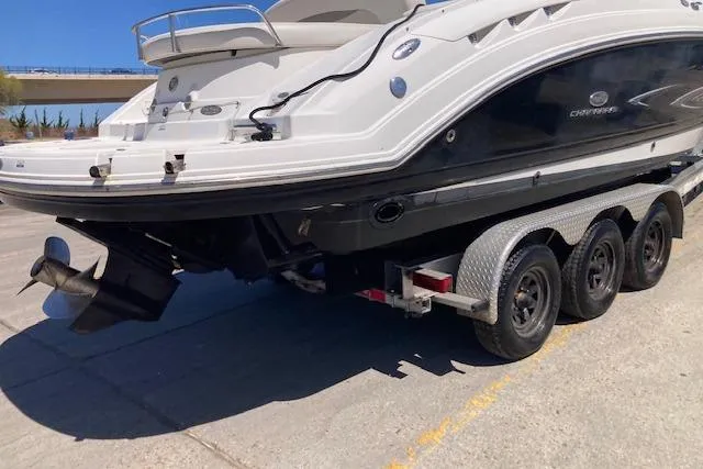 Slide: The Image of 2006 Chaparral 276 SSi boat on a triple-axle trailer, parked on concrete. - 11