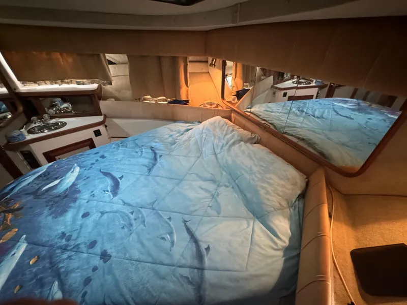 Slide: The Image of Interior cabin of 1986 Carver 36 Mariner with dolphin-themed bedding. - 11