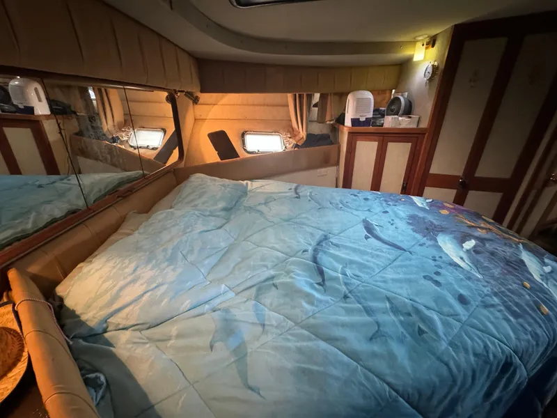 Slide: The Image of Interior cabin of 1986 Carver 36 Mariner with bed and mirrored wall. - 12