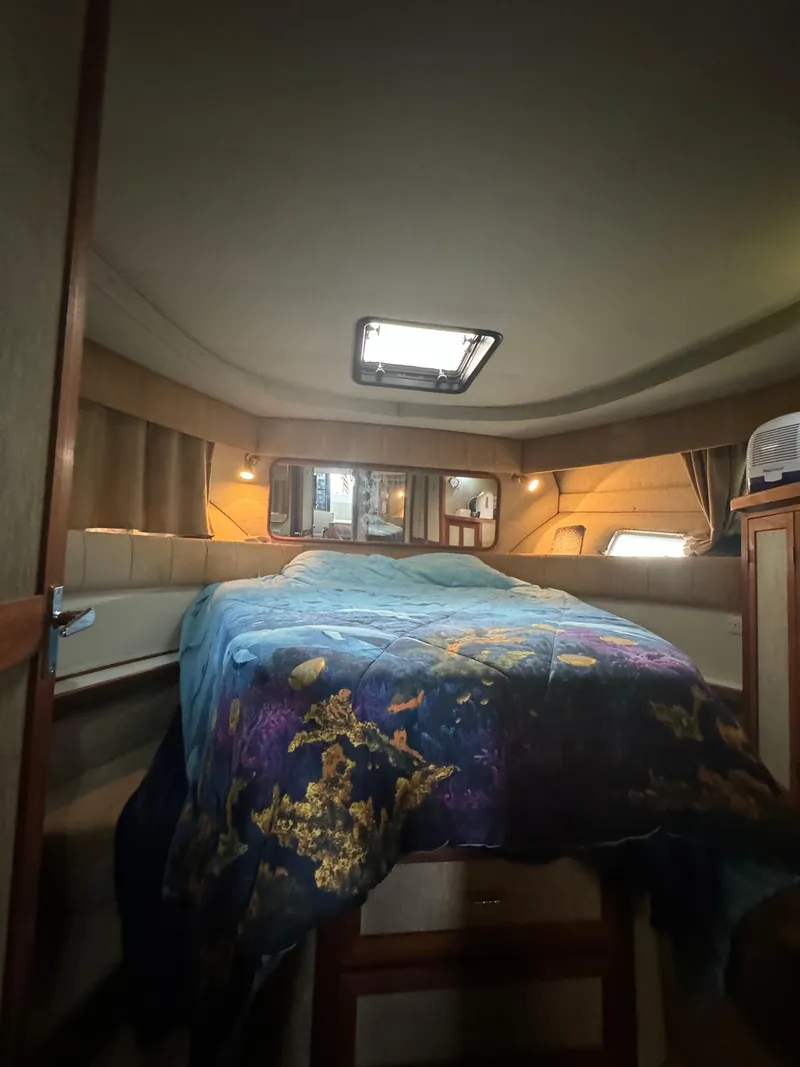 Slide: The Image of Interior cabin of a 1986 Carver 36 Mariner with a colorful bedspread. - 13
