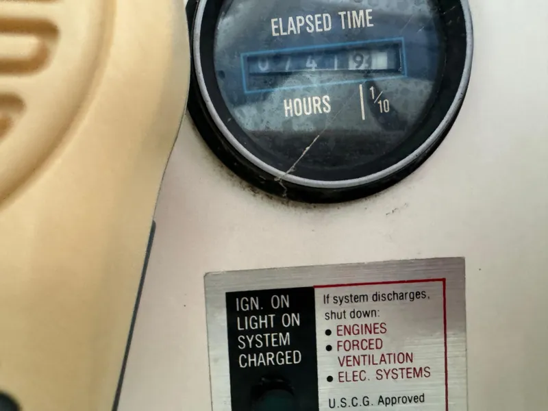 Slide: The Image of Elapsed time meter and safety instructions on a 1986 Carver 36 Mariner boat. - 25
