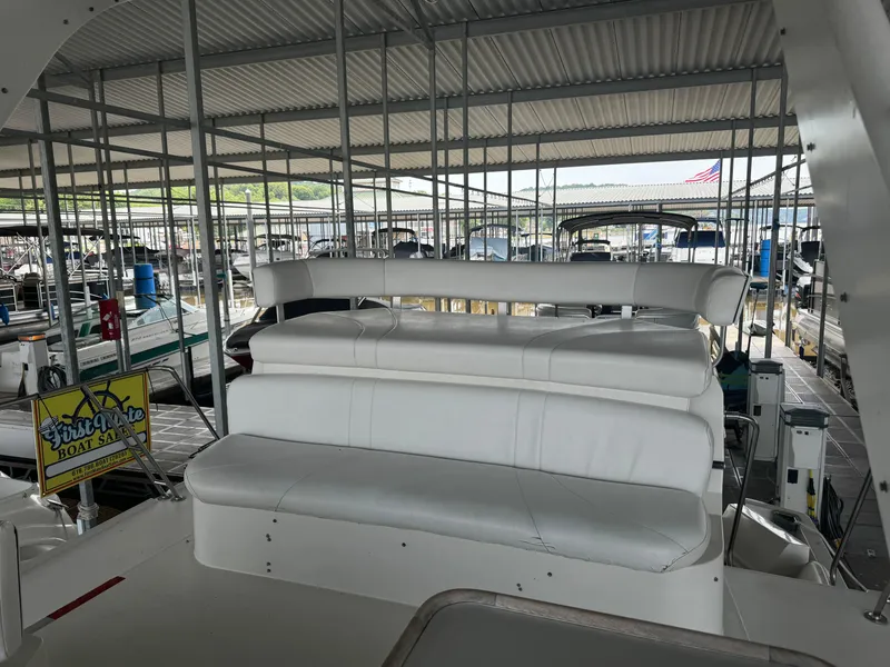 Slide: The Image of 1986 Carver 36 Mariner boat interior with white seating in a covered marina. - 7