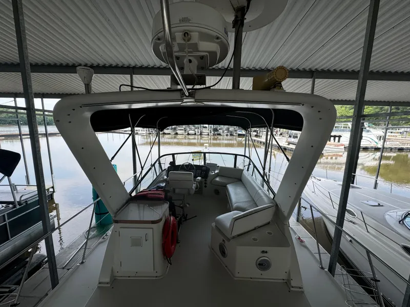 Slide: The Image of 1986 Carver 36 Mariner yacht interior, docked in a covered marina. - 8