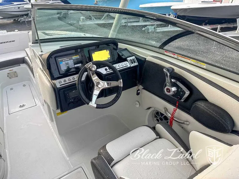 Slide: The Image of 2024 Finseeker 240 DC boat cockpit with steering wheel and control panel. - 10