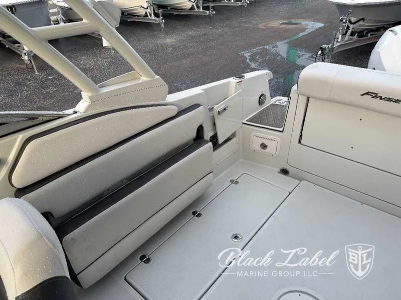 Slide: The Image of 2024 Finseeker 240 DC boat interior with seating and storage compartments. - 11