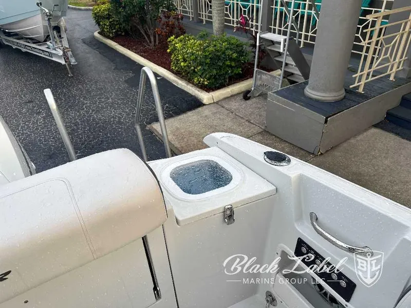 Slide: The Image of 2024 Finseeker 240 DC boat rear view with livewell and Black Label Marine Group logo. - 12