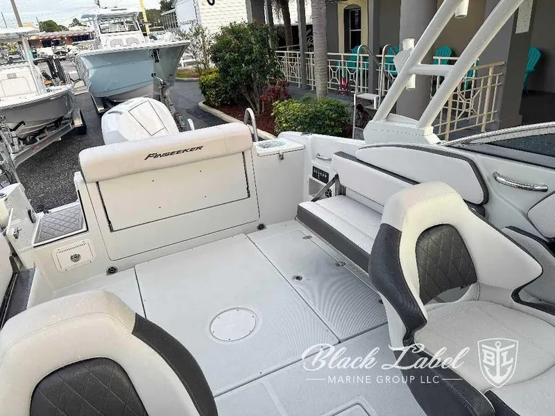 Slide: The Image of 2024 Finseeker 240 DC boat interior with seating and deck, Black Label Marine Group logo. - 4