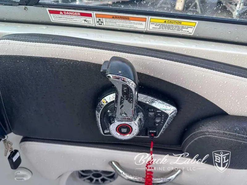 Slide: The Image of Close-up of 2024 Finseeker 240 DC boat throttle control with safety warnings. - 9