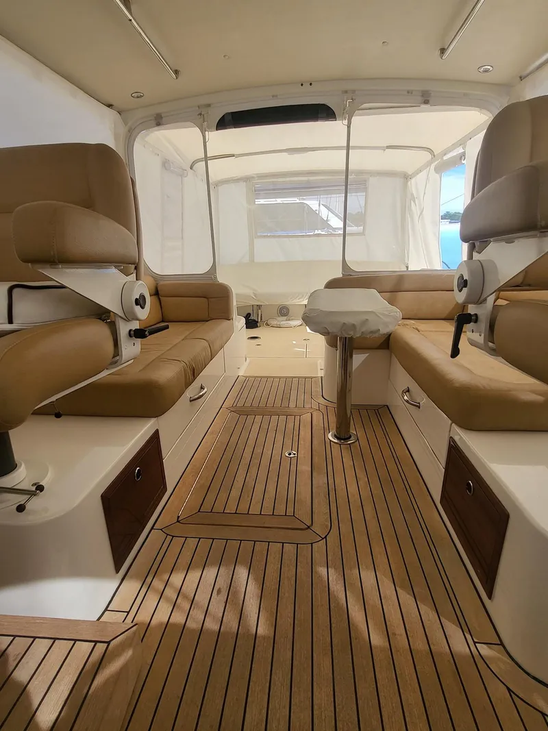 Slide: The Image of 2013 MJM 40z Downeast boat interior with teak flooring and beige seating. - 10