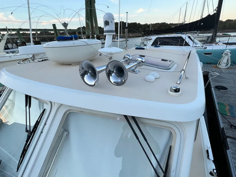Slide: The Image of 2013 MJM 40z Downeast boat with deck details and docked sailboats in background. - 16