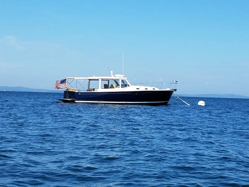 Slide: The Image of 2013 MJM 40z Downeast boat anchored on calm blue water. - 21