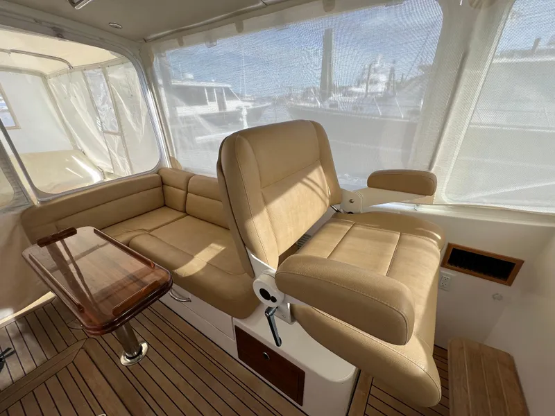 Slide: The Image of Interior of 2013 MJM 40z Downeast boat with beige seating and wooden flooring. - 28