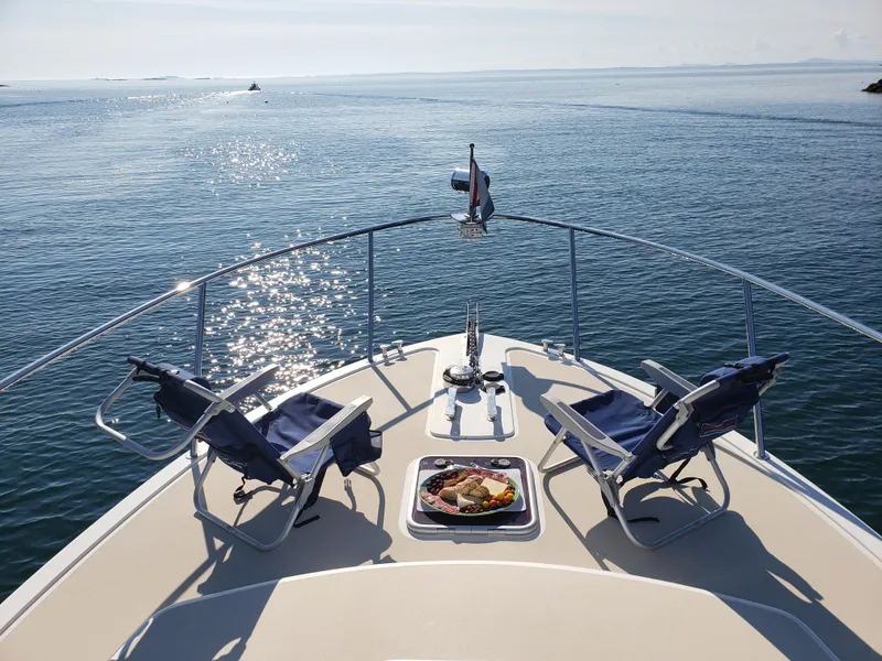 Slide: The Image of 2013 MJM 40z Downeast boat with deck chairs and food tray on calm water. - 3