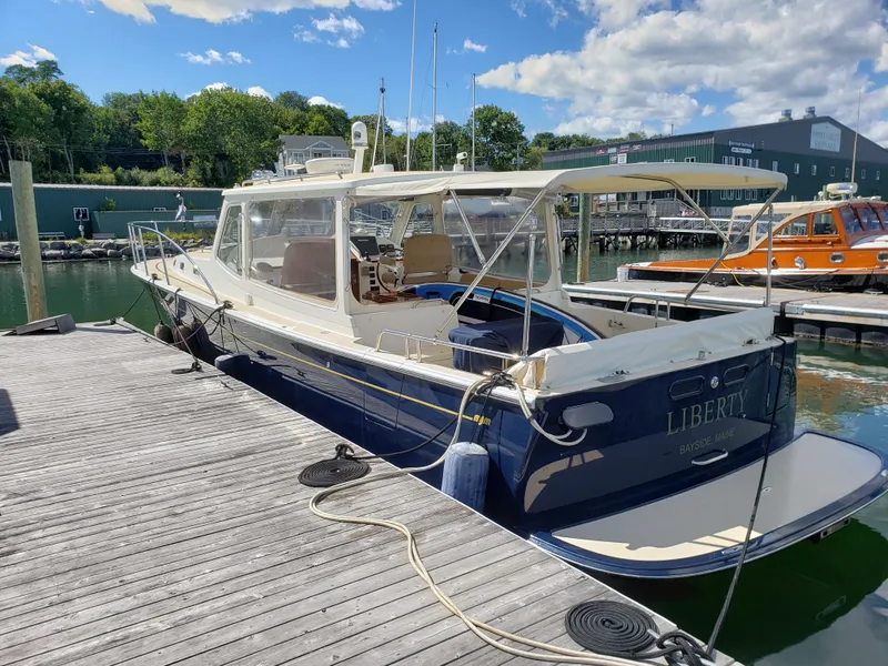 The Image of 2013 MJM 40z Downeast boat docked at a marina on a sunny day. - 1