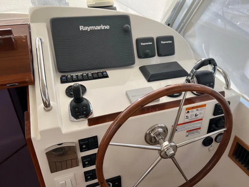 Slide: The Image of 2013 MJM 40z Downeast helm with Raymarine electronics and wooden steering wheel. - 26