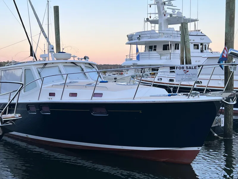 Slide: The Image of 2013 MJM 40z Downeast boat docked at marina, sunset background. - 4