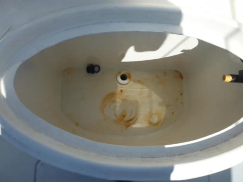 Slide: The Image of 2000 Seaswirl 2300 Walk Around boat livewell with stains and drain plug. - 12