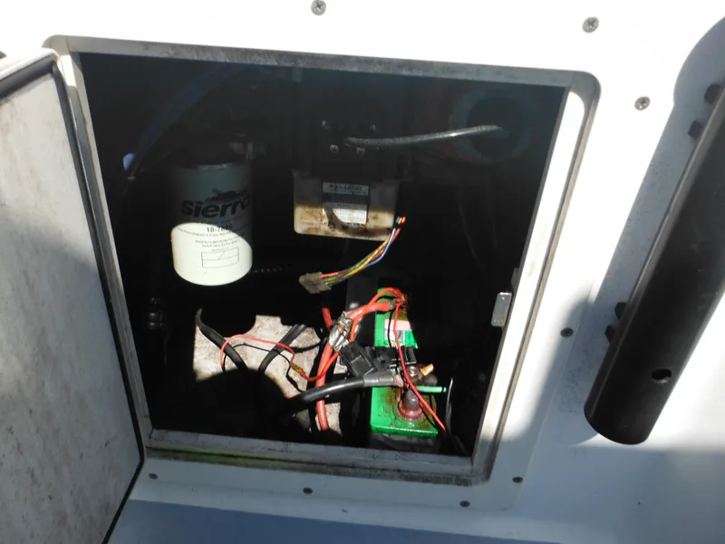 Slide: The Image of 2000 Seaswirl 2300 Walk Around boat engine compartment with wiring and Sierra filter. - 14