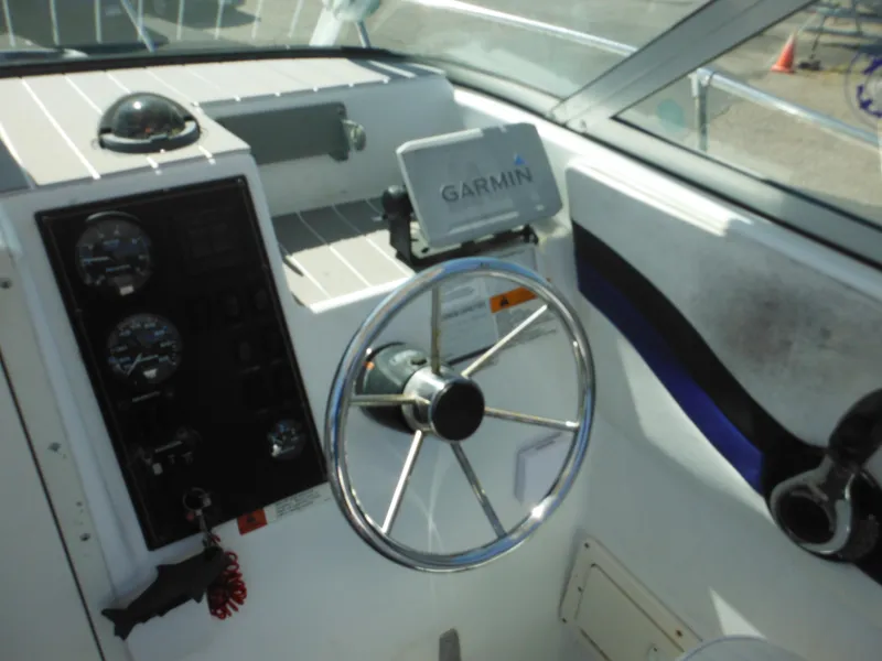 Slide: The Image of 2000 Seaswirl 2300 Walk Around boat helm with Garmin GPS and steering wheel. - 19