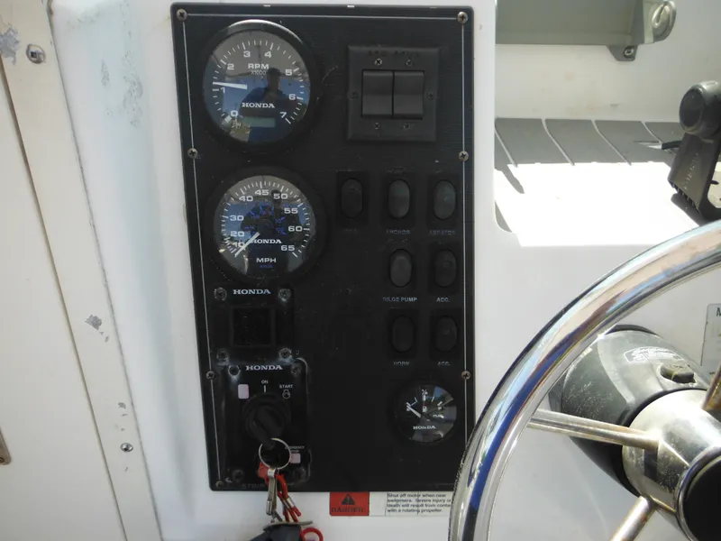 Slide: The Image of Control panel of a 2000 Seaswirl 2300 Walk Around boat with gauges and switches. - 21