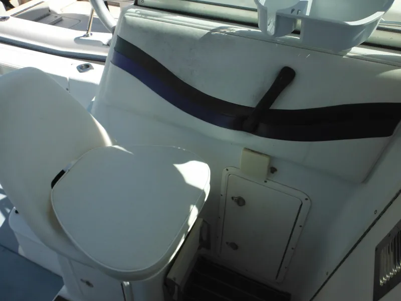 Slide: The Image of 2000 Seaswirl 2300 Walk Around boat interior with seating and storage compartments. - 22