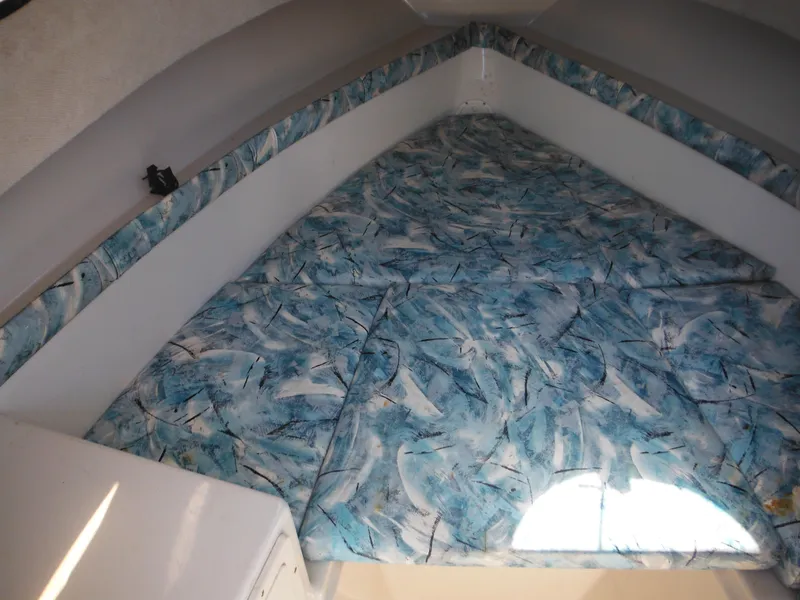 Slide: The Image of Interior cabin of 2000 Seaswirl 2300 Walk Around boat with patterned bedding. - 24