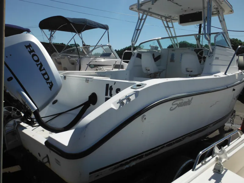 Slide: The Image of 2000 Seaswirl 2300 Walk Around boat with Honda outboard motor. - 3
