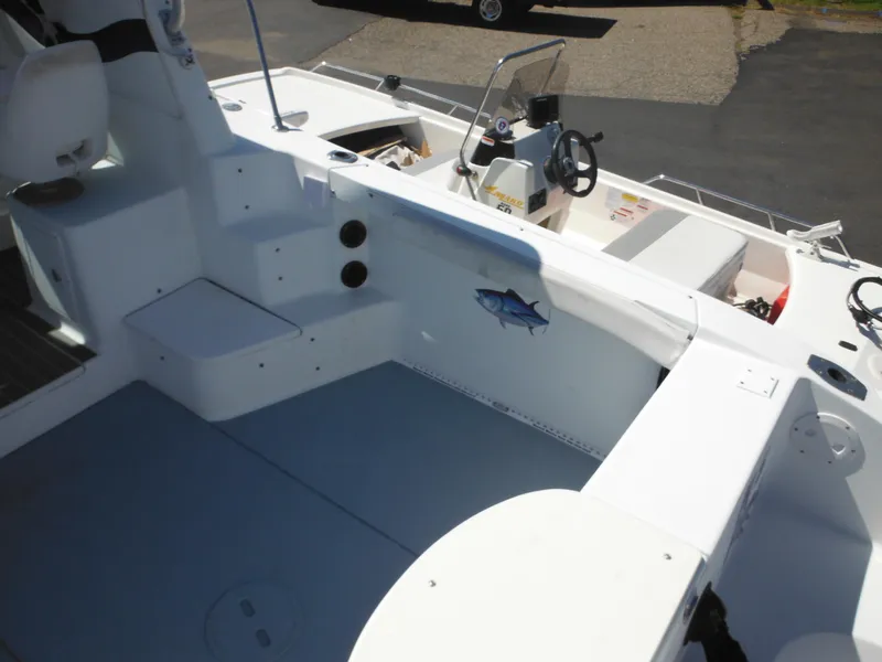 Slide: The Image of 2000 Seaswirl 2300 Walk Around boat interior, featuring seating and steering console. - 9
