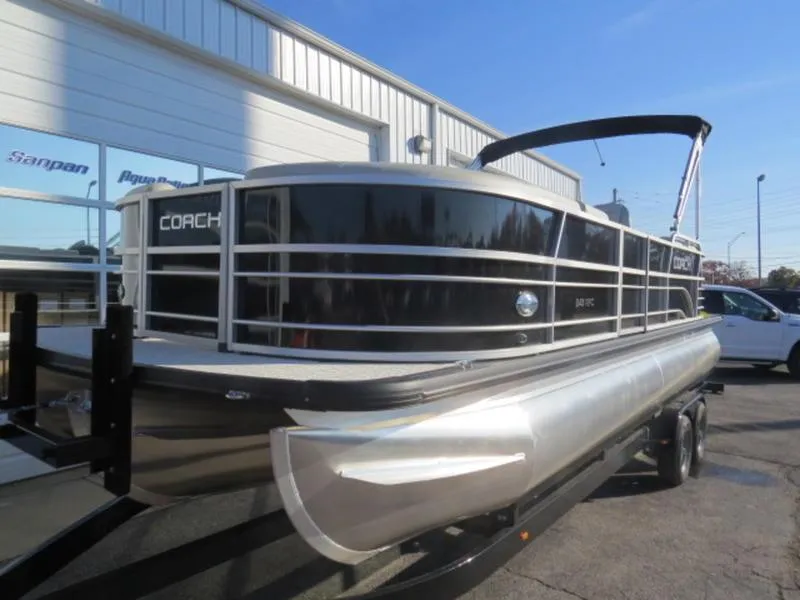 Slide: The Image of 2023 Coach Pontoons 243 RFC pontoon boat on a trailer outside a dealership. - 4