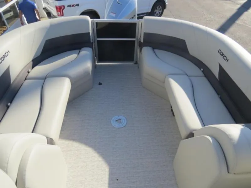 Slide: The Image of 2023 Coach Pontoons 243 RFC interior seating area with plush, curved benches. - 9