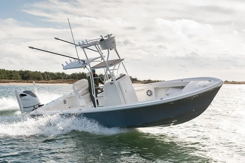 The Image of 2027 Pair Customs 24DV boat cruising on open water, showcasing sleek design and performance. - 2