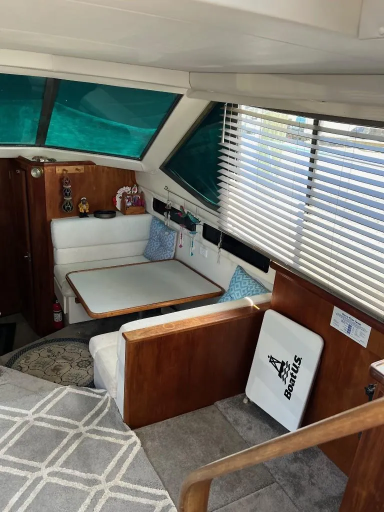 Slide: The Image of Interior of 1994 Carver 355 Aft Cabin with dining area and large windows. - 12