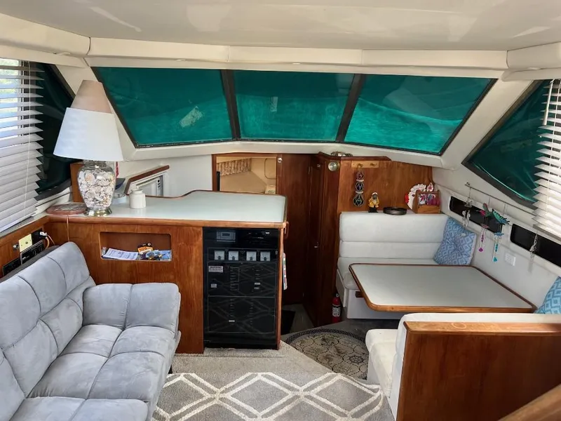 Slide: The Image of Interior of 1994 Carver 355 Aft Cabin yacht with seating and dining area. - 14