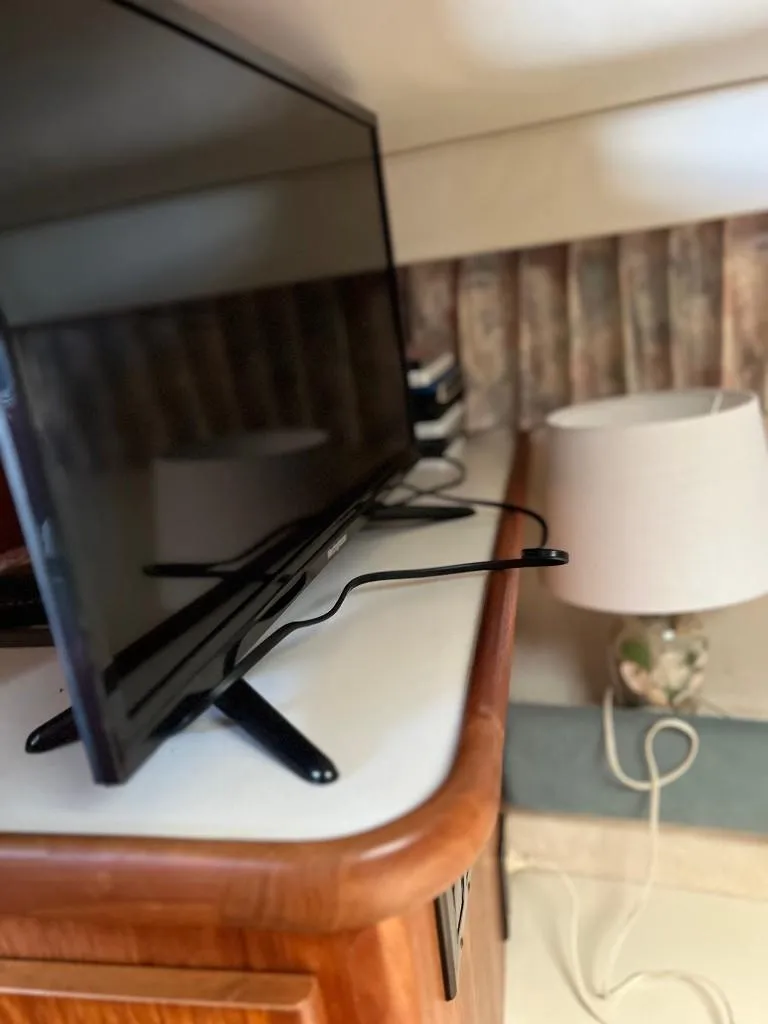 Slide: The Image of Flat-screen TV and lamp in the cabin of a 1994 Carver 355 Aft Cabin yacht. - 16